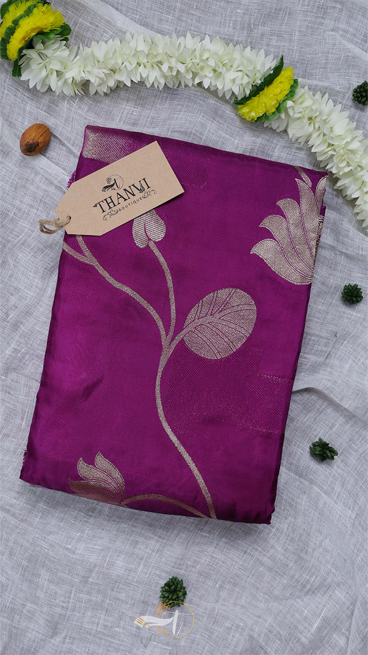Purple fabric with floral patterns on a gray surface with decorative elements