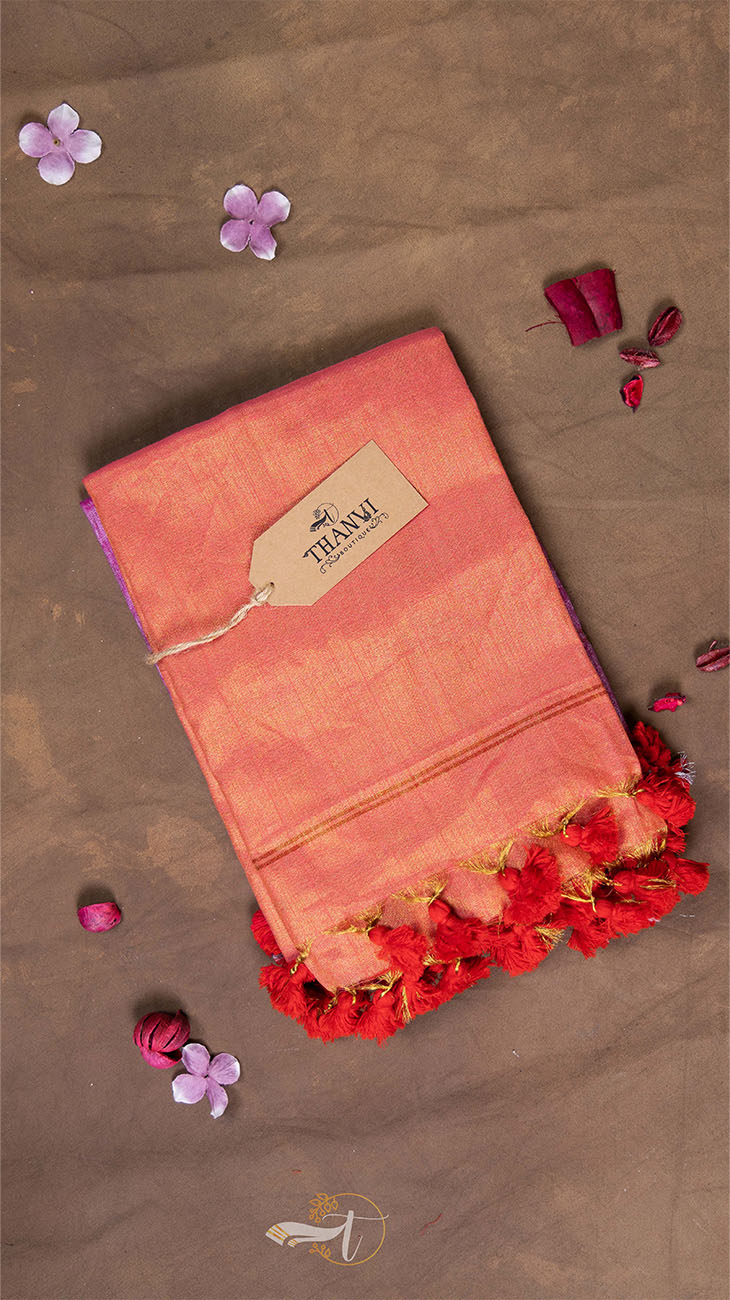 Pink saree with red border and 'Thambi' brand tag on a brown background