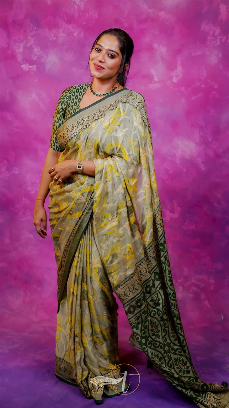 Woman wearing a traditional saree with a vibrant pink background