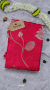 Red fabric with floral design and 'THANU' tag on a textured surface