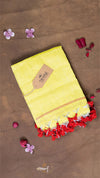 Yellow fabric with red and white trim on a brown background