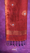 Red fabric with gold patterns on a purple background
