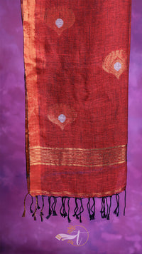 Red fabric with gold patterns on a purple background
