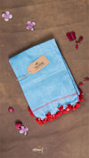 Blue fabric with red trim on a brown background