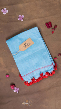 Blue fabric with red trim on a brown background