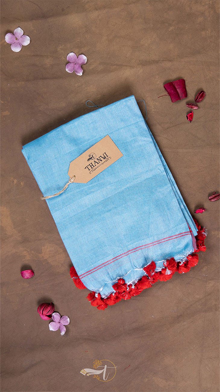 Blue fabric with red trim on a brown background