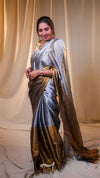 Woman wearing a traditional saree with a plain background