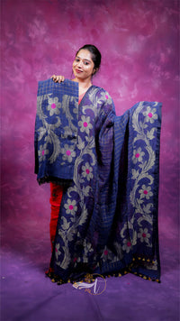 Woman holding a blue embroidered saree against a purple background