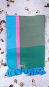 Green and blue towel with a pink stripe on a light background