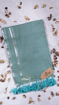 Teal scarf with tassels on a light background