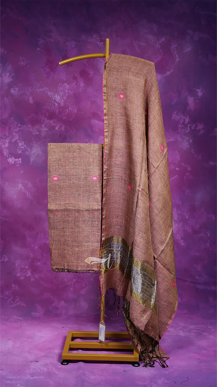 Brown fabric with pink dots on a wooden stand against a purple textured background