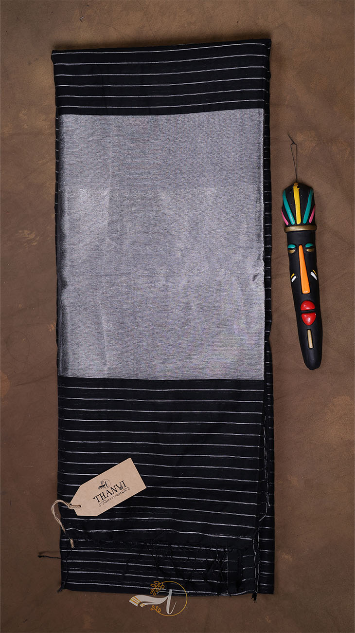 Gray and black striped fabric with a tag on a brown background