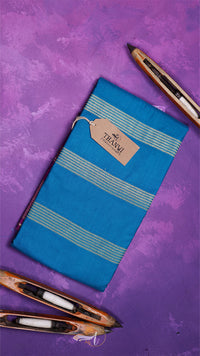 Blue notebook with striped design and a tag on a purple background