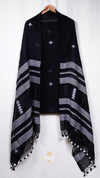 Black poncho with white patterns and tassels on a white background