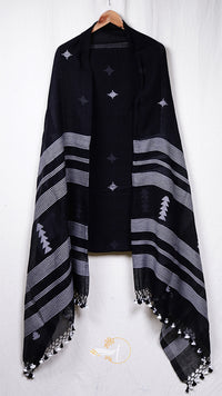 Black poncho with white patterns and tassels on a white background