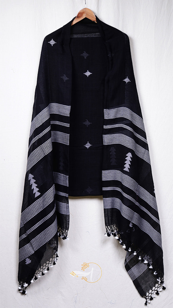 Black poncho with white patterns and tassels on a white background