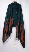 Dark green and brown patterned scarf draped over a white background