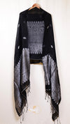 Black and white patterned scarf on a hanger against a white background