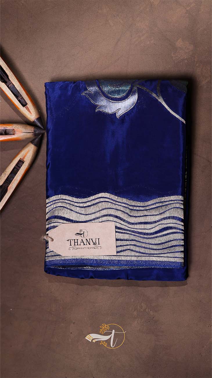 Blue fabric with white patterns on a brown background, featuring the 'THANVI' brand.
