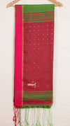 Red and green saree with a white border on a wooden hanger against a white background