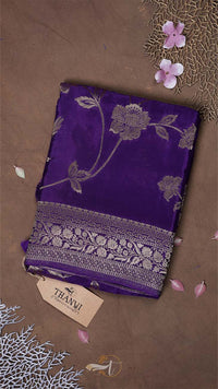 Purple fabric with floral patterns on a brown background