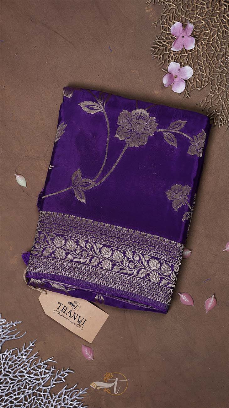 Purple fabric with floral patterns on a brown background