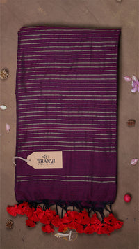 Purple scarf with white stripes and red tassels on a brown background