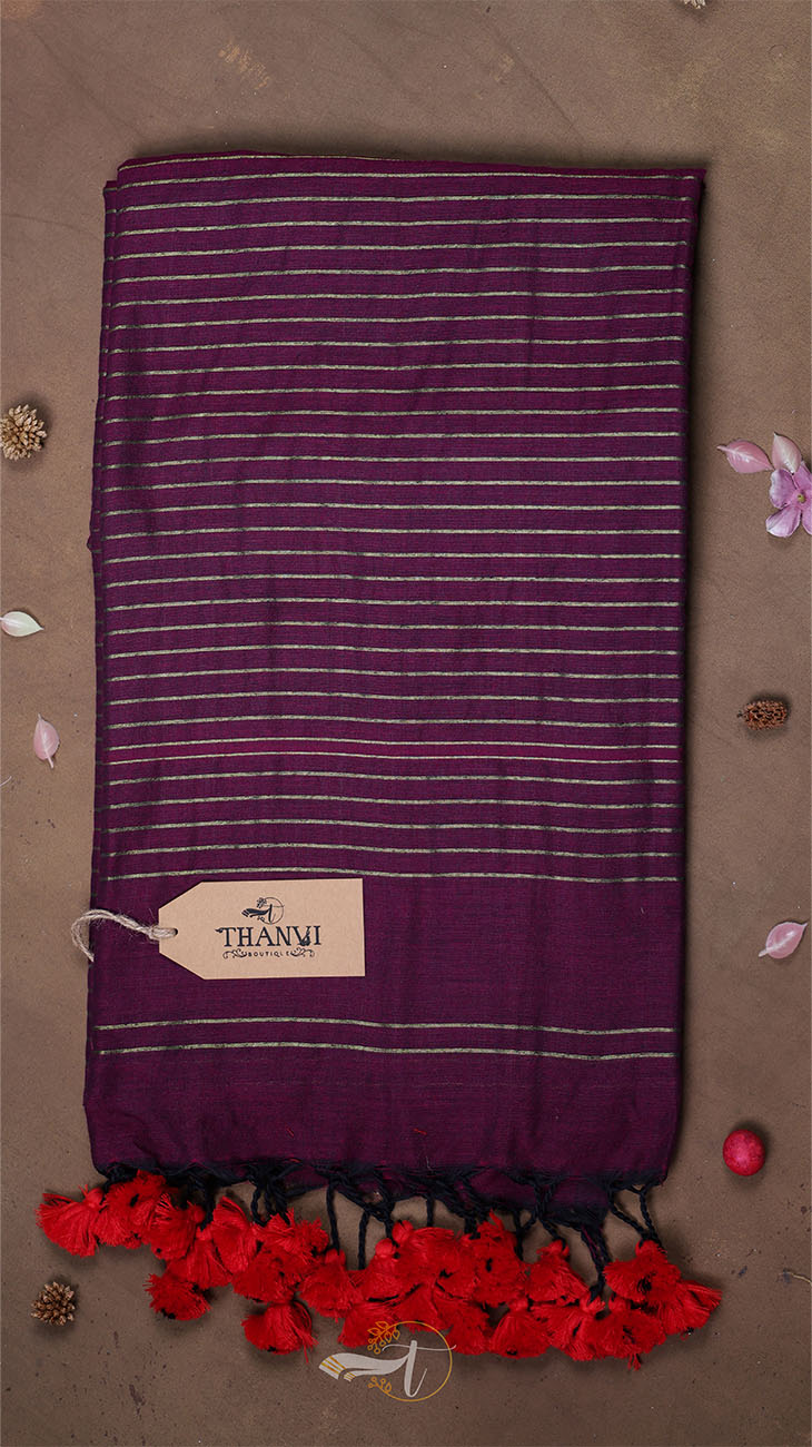Purple scarf with white stripes and red tassels on a brown background