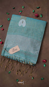 Teal towel with white patterns on a brown background