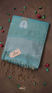 Teal towel with white patterns on a brown background