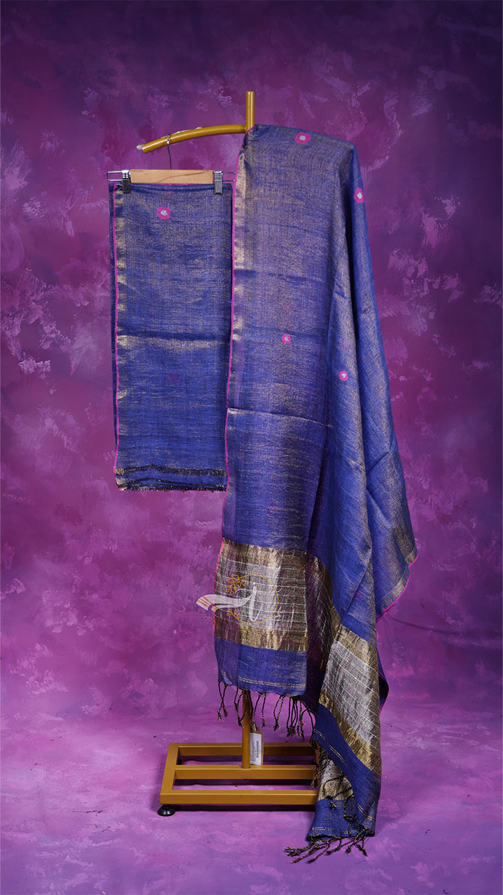 Blue patterned fabric draped over a wooden stand against a purple background