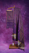 Purple and brown patterned fabric on a wooden stand against a purple background