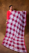 Woman holding a red and white checkered scarf against a brown background