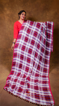 Woman holding a red and white checkered scarf against a brown background