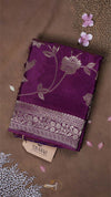 Purple fabric with floral patterns on a brown background