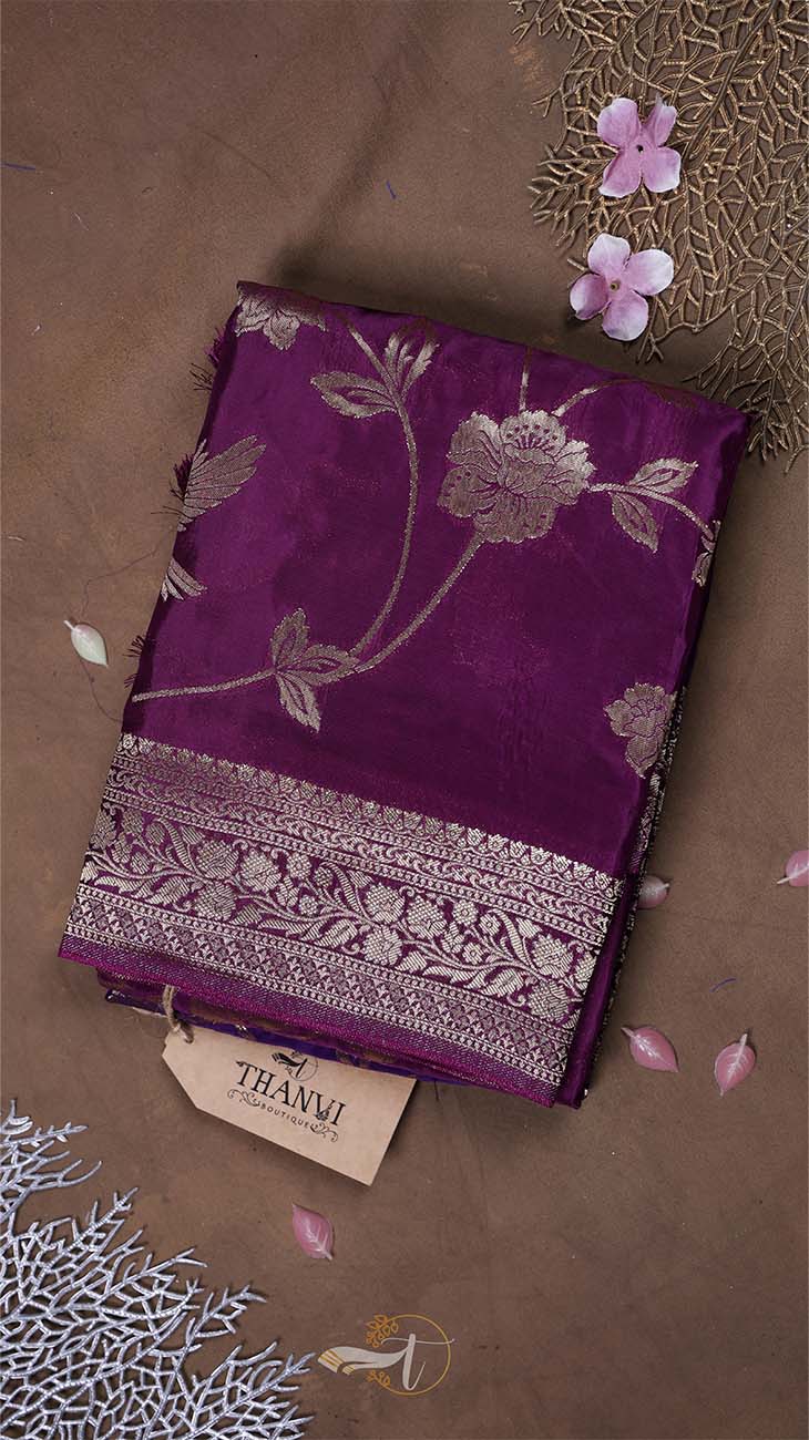 Purple fabric with floral patterns on a brown background