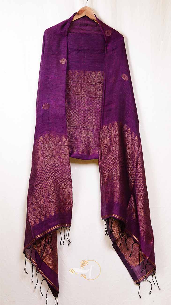 Purple scarf with intricate patterns and tassels on a white background