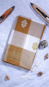 Notebook with decorative cover on a textured surface with writing instruments and decorative items.