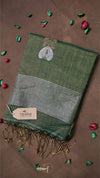 Green scarf with embroidered design on a brown background