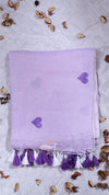Lavender towel with heart patterns and tassels on a light gray background with decorative elements.