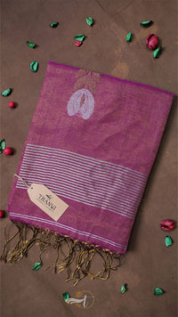 Purple scarf with white design and fringes on a brown background