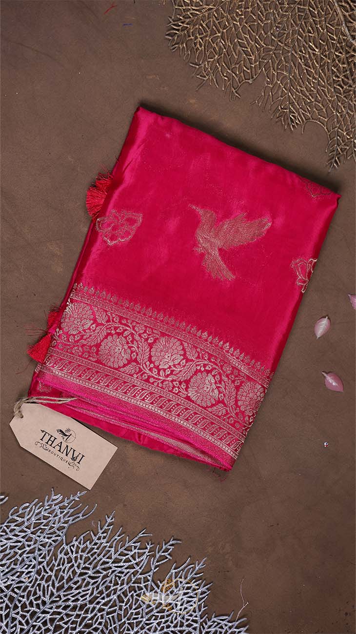 Pink fabric with intricate patterns on a brown background