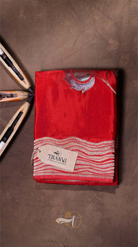 Red fabric with white patterns and a brand label on a brown background