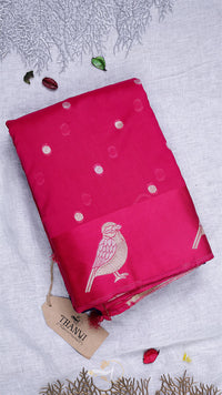 Pink fabric with bird design on a textured surface