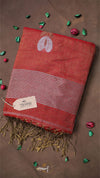Red scarf with white leaf design and fringes on a brown background