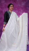 Woman wearing a white saree with a black blouse against a purple background