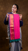 Woman holding a pink and orange traditional scarf against a brown background