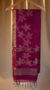 Pink floral patterned fabric on a hanger against a neutral background
