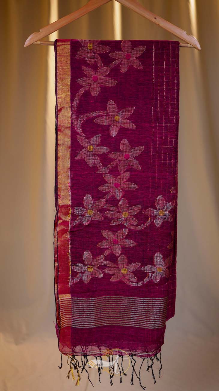 Pink floral patterned fabric on a hanger against a neutral background