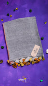Gray fabric with colorful tassels on a purple background